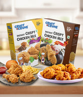 Two boxes of Crust & crumb Instant Crispy Chicken Mix original & pepper & spicy with fried chicken and sides on a table.